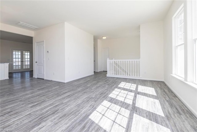 unfurnished room featuring hardwood / wood-style flooring and french doors