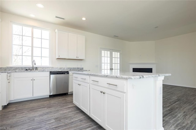 kitchen featuring sink, dishwasher, a center island, white cabinets, and dark hardwood / wood-style flooring