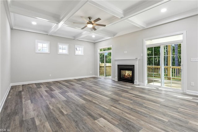 unfurnished living room featuring ceiling fan, hardwood / wood-style floors, beam ceiling, a multi sided fireplace, and coffered ceiling