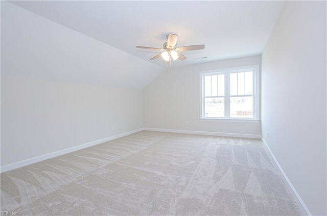 bonus room featuring lofted ceiling, light colored carpet, and ceiling fan