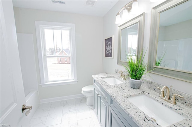 full bathroom with vanity, shower / tub combination, and toilet