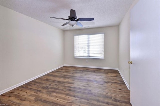 unfurnished room with ceiling fan, dark hardwood / wood-style flooring, and a textured ceiling