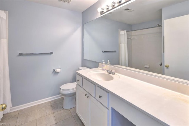 bathroom featuring vanity, tile patterned floors, and toilet