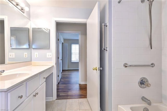 bathroom featuring tiled shower / bath, tile patterned floors, and vanity