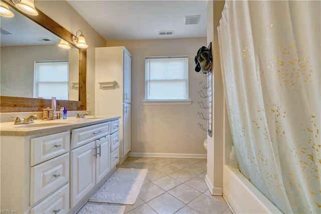 bathroom with vanity, a wealth of natural light, tile patterned floors, and shower / bath combo with shower curtain