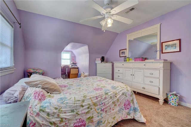 bedroom with ceiling fan, lofted ceiling, and light colored carpet