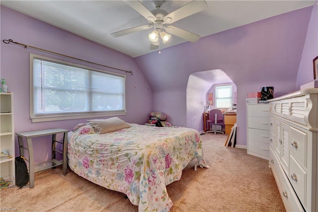 carpeted bedroom featuring lofted ceiling and ceiling fan