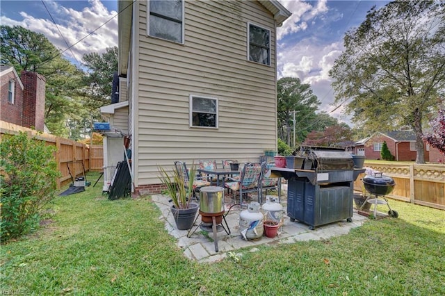 rear view of property with a lawn