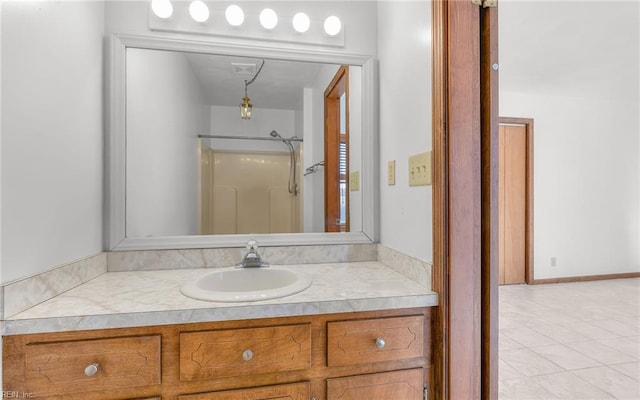 bathroom with vanity and a shower