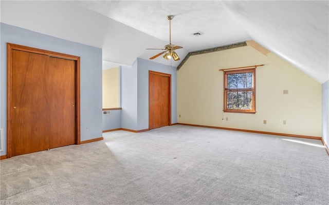 bonus room with lofted ceiling, light carpet, and ceiling fan