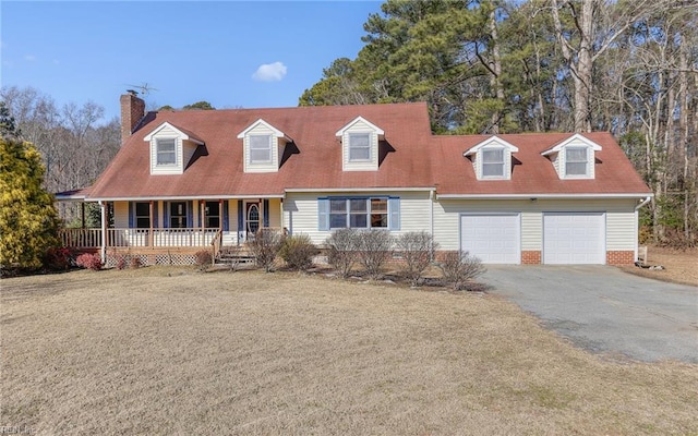 cape cod house with a garage, covered porch, and a front yard