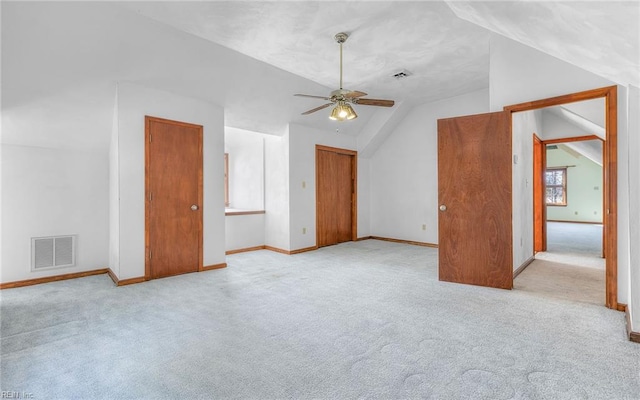 additional living space featuring ceiling fan, lofted ceiling, and light carpet