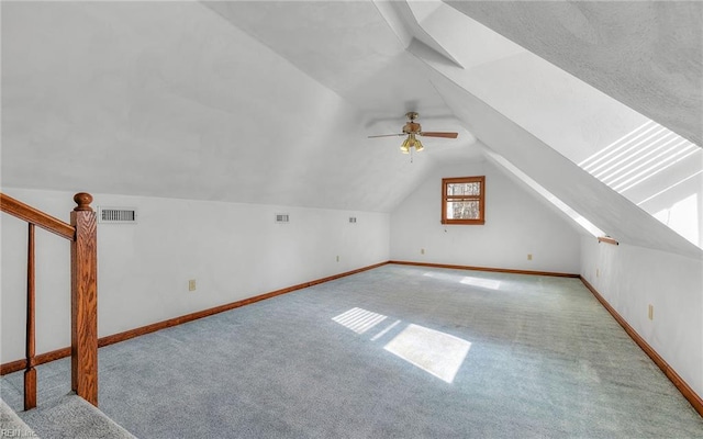 bonus room featuring ceiling fan, light colored carpet, and lofted ceiling