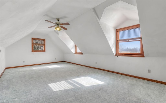 additional living space with lofted ceiling, light colored carpet, and ceiling fan