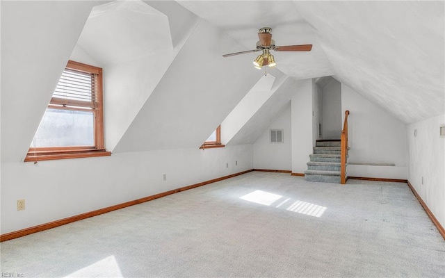 bonus room with light carpet, lofted ceiling, and ceiling fan