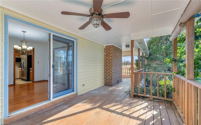 wooden deck featuring ceiling fan