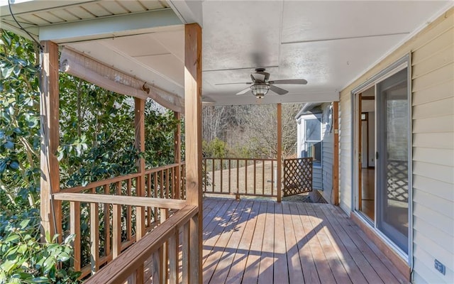 wooden deck featuring ceiling fan