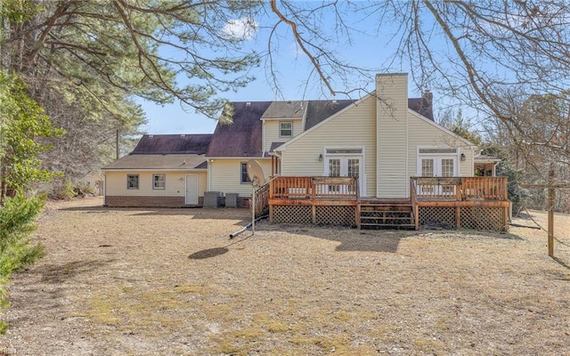 back of property with a wooden deck, central AC, and french doors