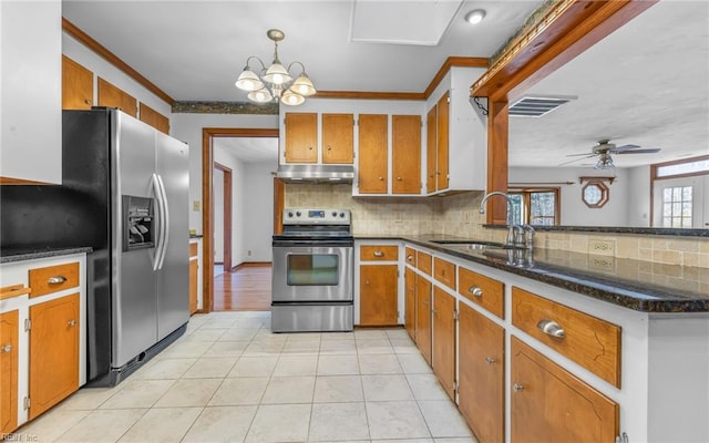 kitchen featuring tasteful backsplash, sink, stainless steel appliances, and light tile patterned flooring