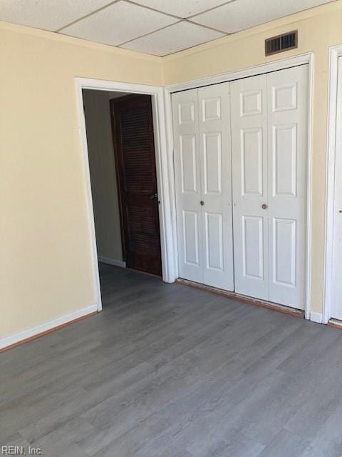 unfurnished bedroom with hardwood / wood-style floors and a closet