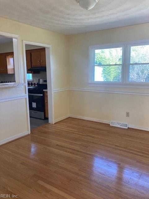 unfurnished dining area featuring wood-type flooring