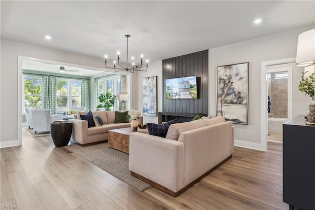 living room featuring an inviting chandelier and light hardwood / wood-style flooring