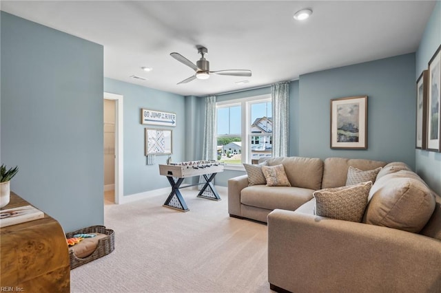 carpeted living room with ceiling fan