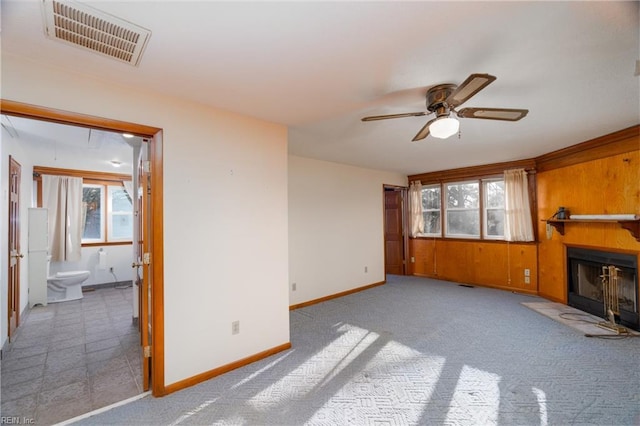 carpeted living room featuring ceiling fan and a healthy amount of sunlight