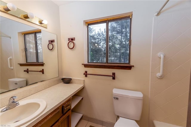 bathroom with vanity, toilet, and tile patterned flooring