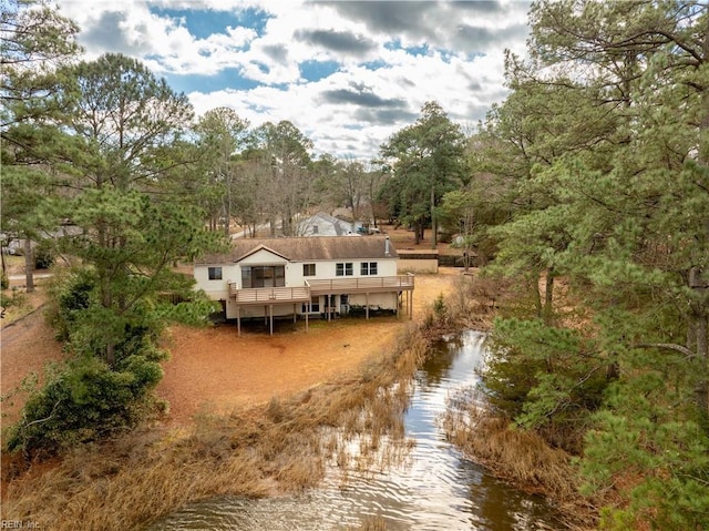 rear view of property with a water view