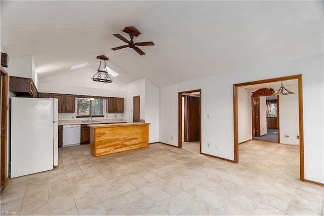 kitchen with ceiling fan, white appliances, sink, and vaulted ceiling