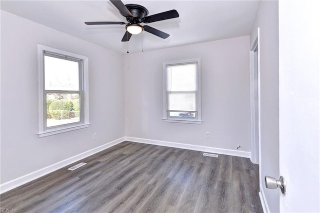 unfurnished room with dark wood-type flooring, a wealth of natural light, and ceiling fan