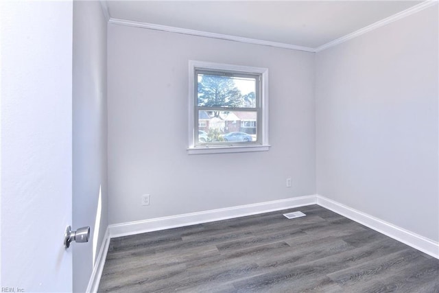 empty room featuring crown molding and dark hardwood / wood-style floors