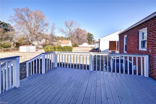 wooden terrace featuring a shed