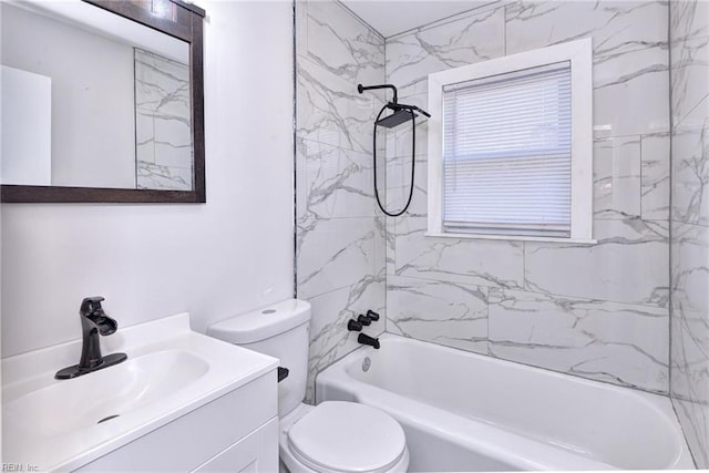 full bathroom featuring tiled shower / bath, vanity, and toilet