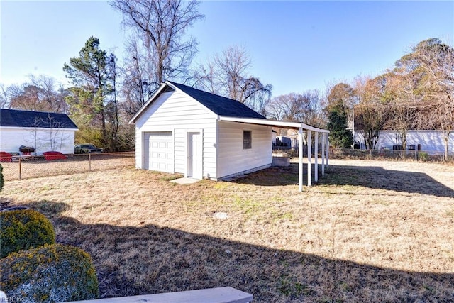 exterior space with a garage, an outdoor structure, and a carport