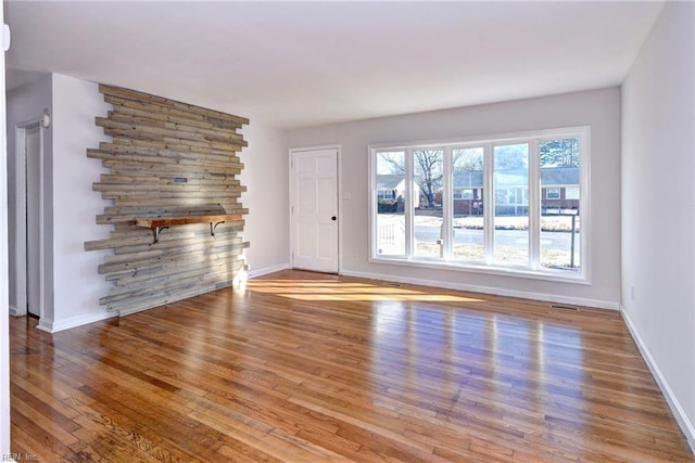 unfurnished living room with hardwood / wood-style floors