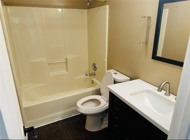 full bathroom with vanity, hardwood / wood-style floors, shower / bathtub combination, and toilet