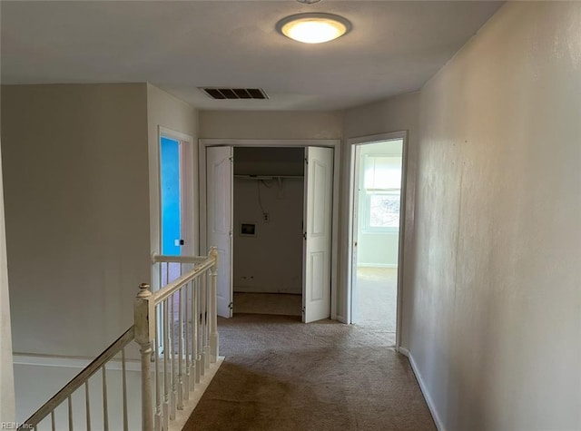 hallway with light colored carpet