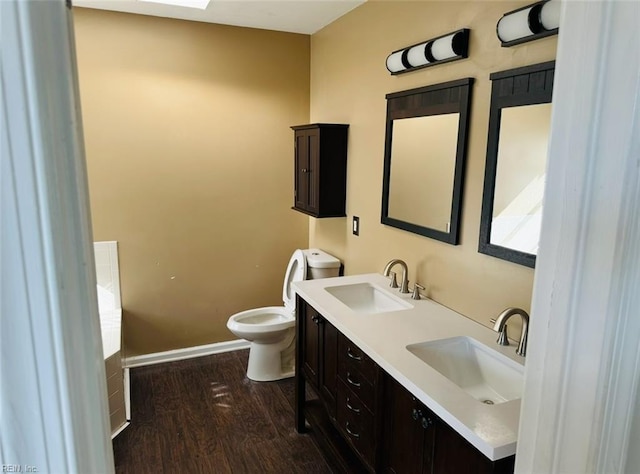 bathroom featuring hardwood / wood-style flooring, vanity, and toilet