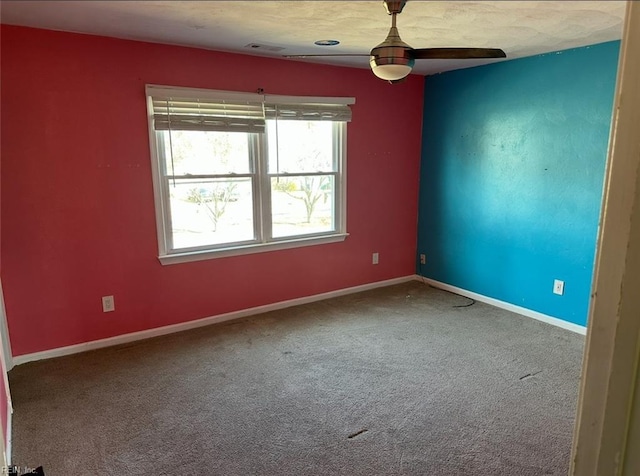 spare room featuring carpet floors and ceiling fan