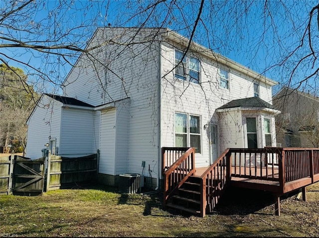 rear view of house with a wooden deck and central air condition unit