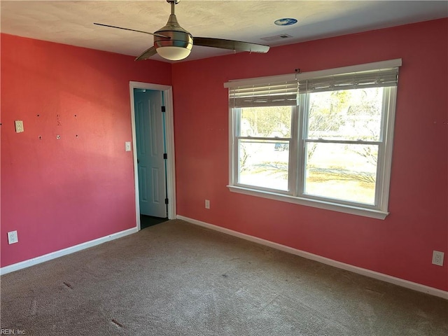 spare room featuring carpet and ceiling fan