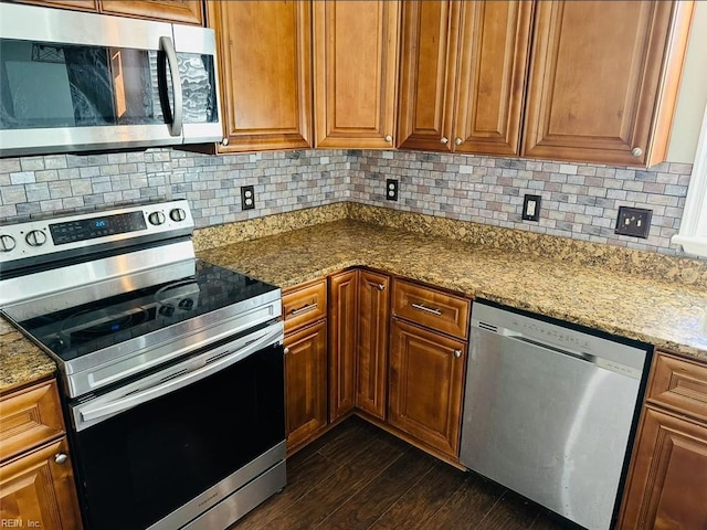 kitchen featuring light stone counters, backsplash, stainless steel appliances, and dark hardwood / wood-style floors