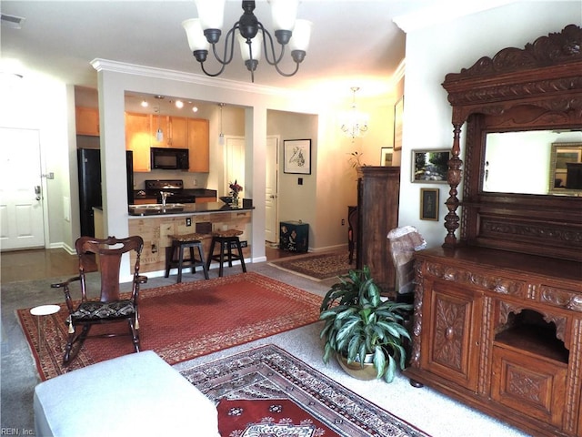 living room featuring ornamental molding and a chandelier