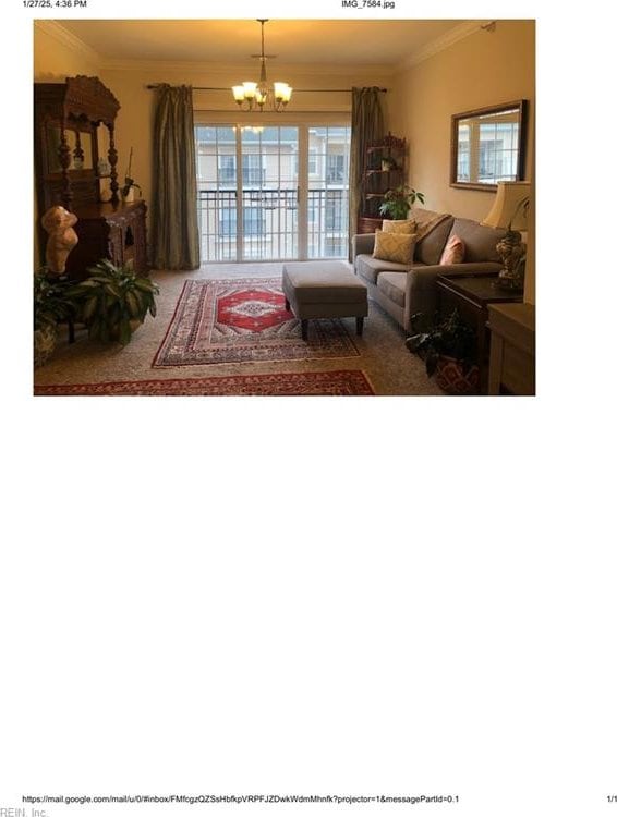 living room with ornamental molding and a notable chandelier