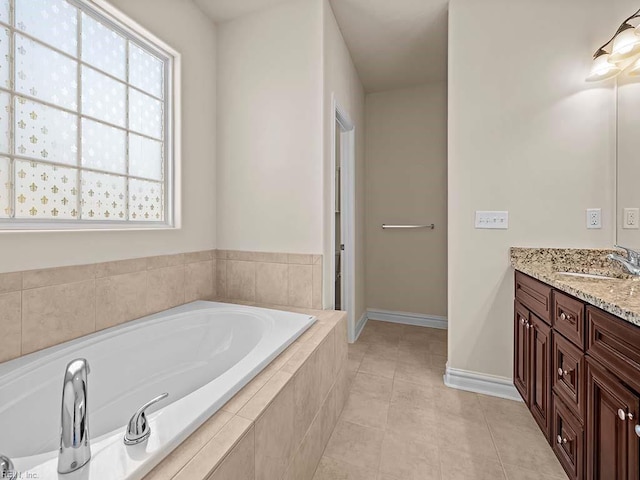 bathroom featuring vanity, tile patterned floors, and tiled bath