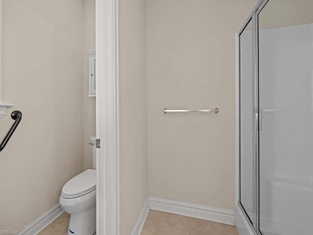 bathroom featuring an enclosed shower, tile patterned floors, and toilet