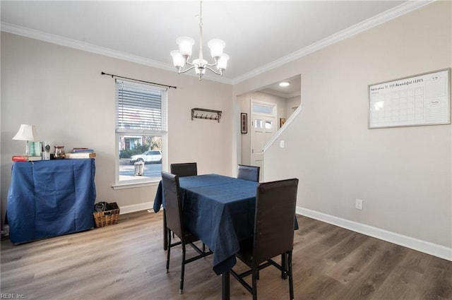 dining space featuring an inviting chandelier, wood-type flooring, and ornamental molding