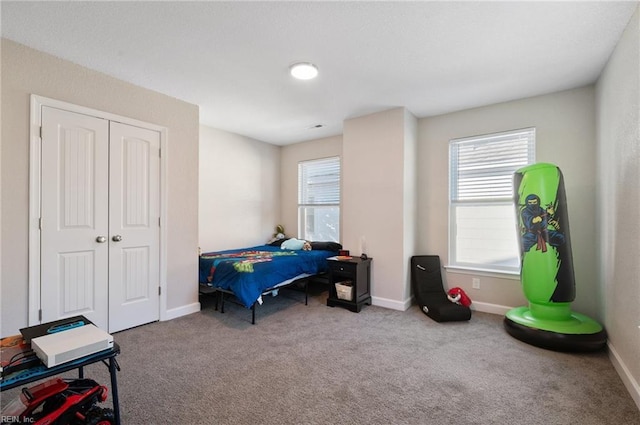 bedroom with light carpet and a closet